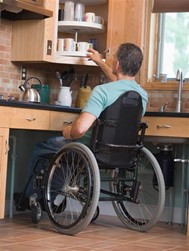 Man in wheelchair in his accessible kitchen