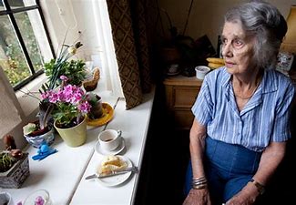 Elderly person sitting alone in house